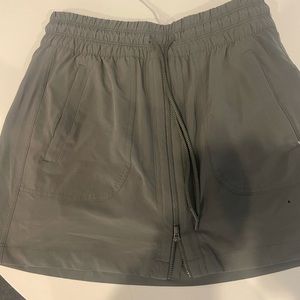 Athleta gray skorts with zipper down front and zippered pockets. Size 4.